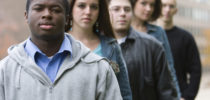 Five college students. Selective focus on the front one.
