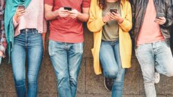 Group of friends using their smart mobile smartphones outdoor - Millennial young people addicted to new technology trends apps - Concept of people, tech, social media, generation z and youth lifestyle